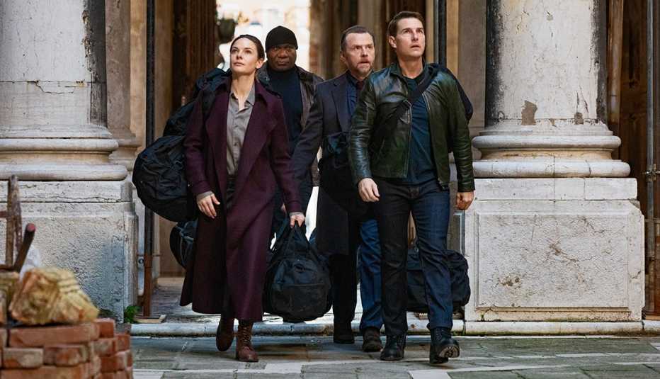 rebecca ferguson ving rhames simon pegg and tom cruise walking together outside in a scene from the film mission impossible dead reckoning part one