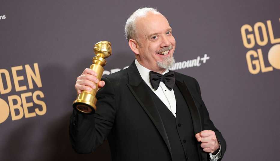 Paul Giamatti poses with the award for Best Performance by a Male Actor in a Motion Picture  Musical or Comedy for "The Holdovers" at the 81st Golden Globe Awards