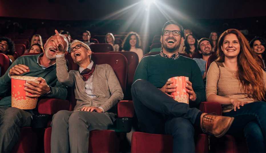people sitting in a movie theater enjoying a film