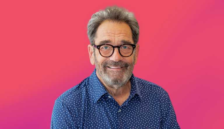 Huey Lewis against pink ombre background