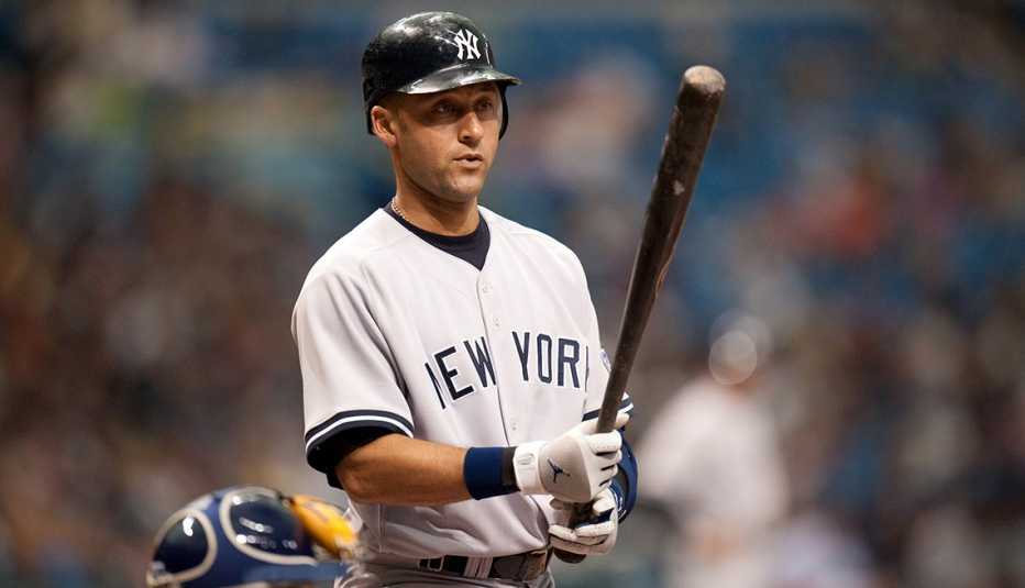 Derek Jeter of the New York Yankees looking at his bat while at the plate during a game in 2009