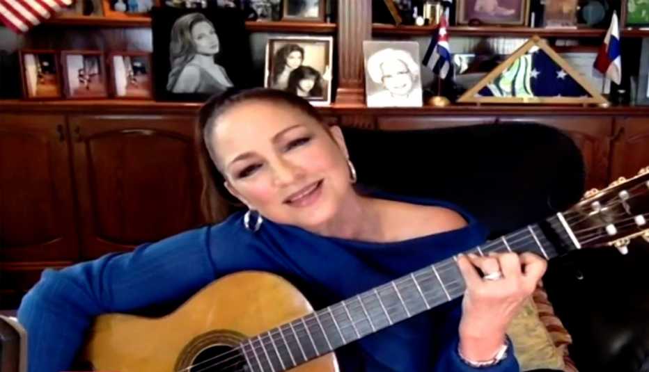 Gloria Estefan performing virtually with an acoustic guitar