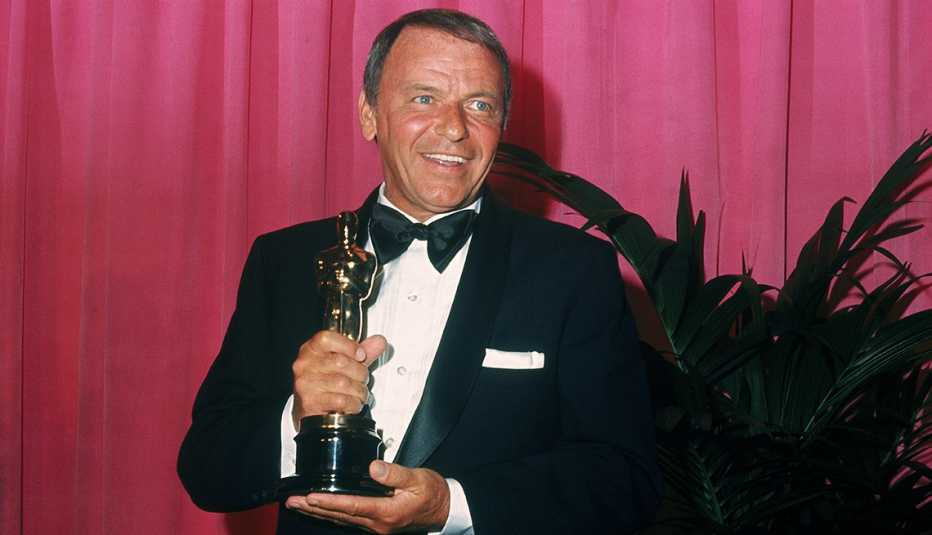 Frank Sinatra holds the Jean Hersholt Humanitarian Award at the Academy Awards