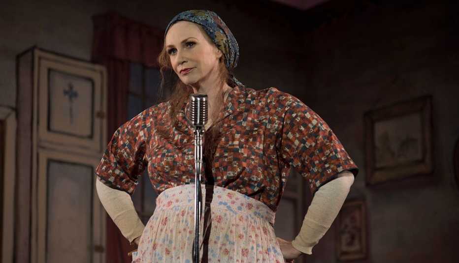 Jane Lynch standing behind a microphone in The Marvelous Mrs Maisel