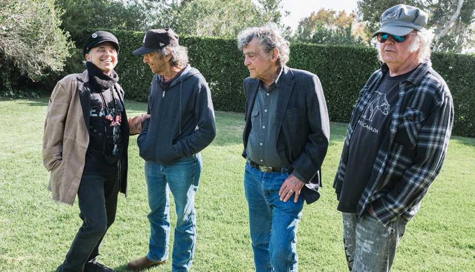 Crazy Horse and Neil Young standing together on a lawn