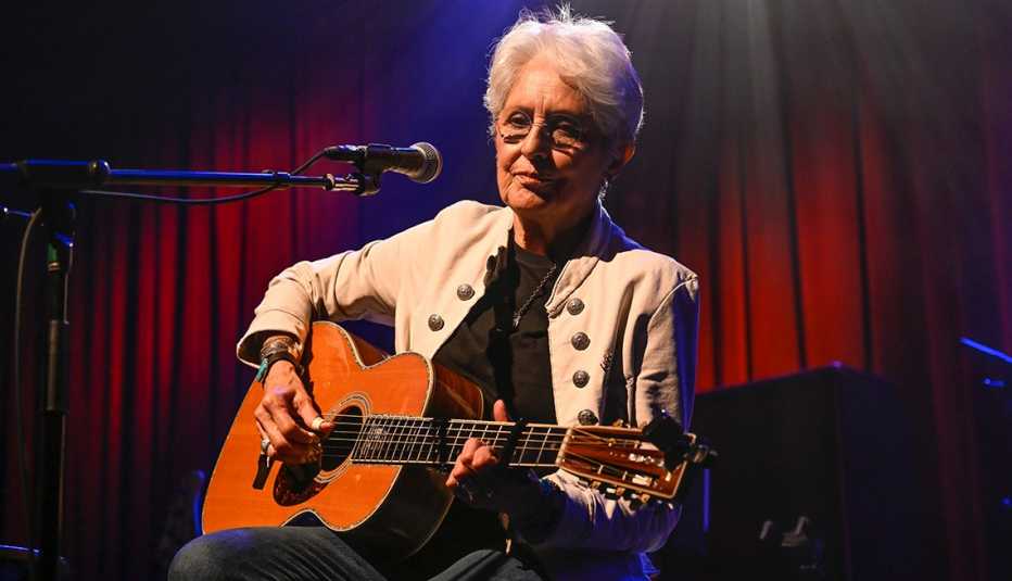 joan baez playing the acoustic guitar onstage at the eighth annual acoustic 4 a cure benefit concert at the fillmore in san francisco