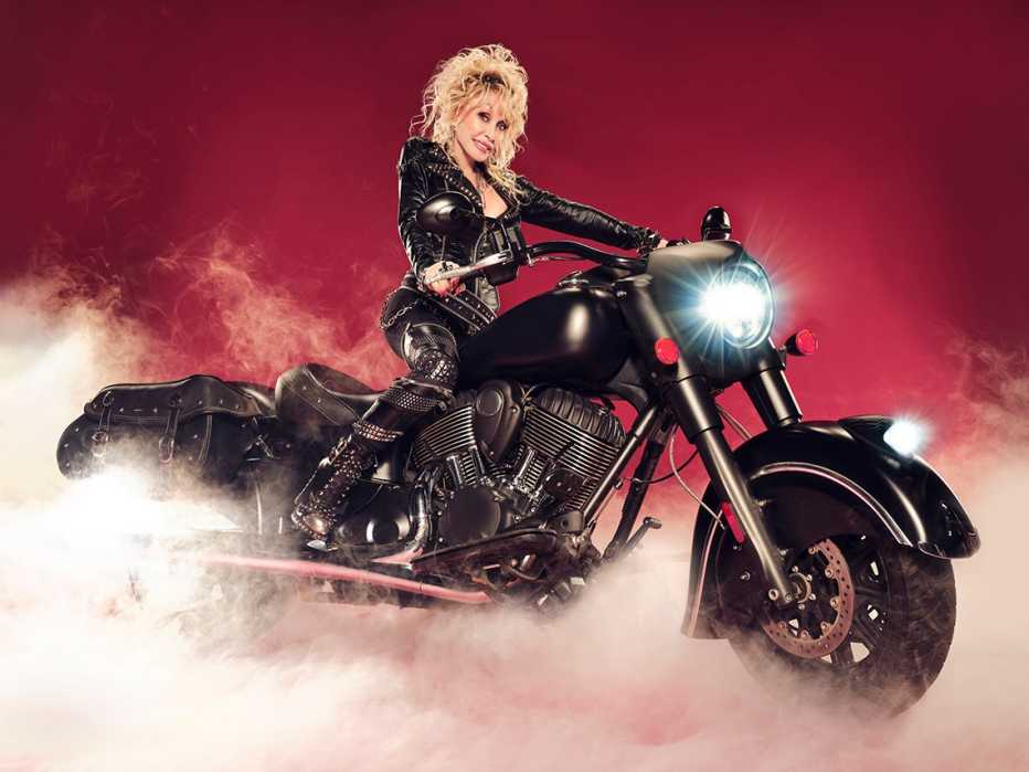 Dolly Parton sitting on a motorcycle