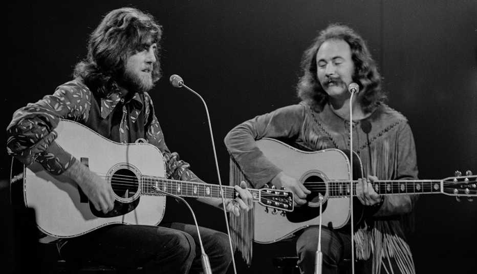 Graham Nash and David Crosby playing their acoustic guitars while performing for the BBC television series 'In Concert' at BBC Television Studios in London in 1970
