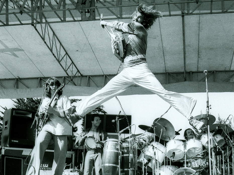 kenny loggins jumping on stage at the memorial auditorium in sacramento california on december seventeenth nineteen seventy four