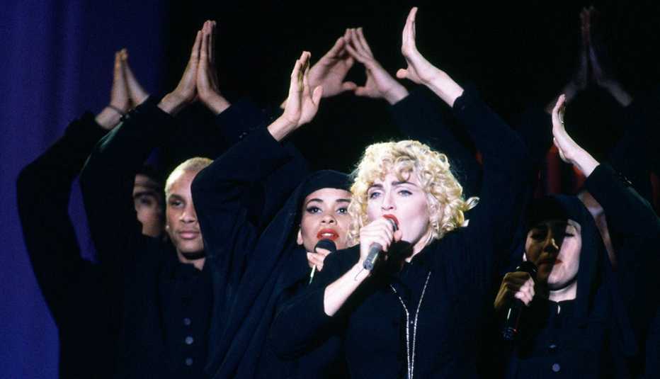Madonna performing during her Blond Ambition World Tour at Wembley Stadium in London, England on July 21, 1990. This was Madonna's third concert tour and promoted her fourth studio album, Like a Prayer (1989). It was attended by an estimated 800,000 people throughout Japan, North America and Europe. The costumes were designed by Jean Paul Gaultier, and included the iconic cone brassiere corset.