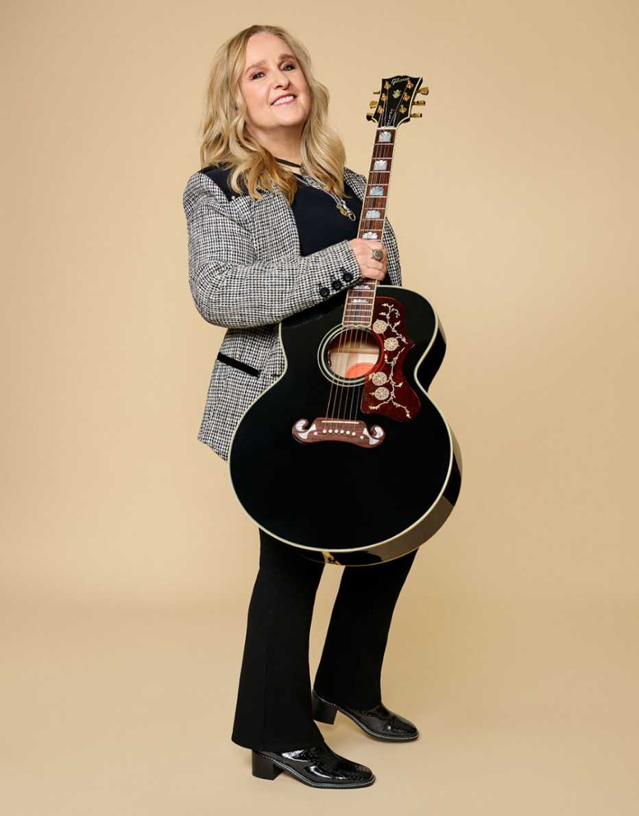 singer songwriter melissa etheridge standing with a guitar