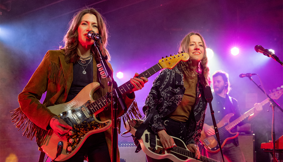 from left to right rebecca lovell and megan lovell and tarka layman of larkin poe performing at the historic scoot inn in austin texas