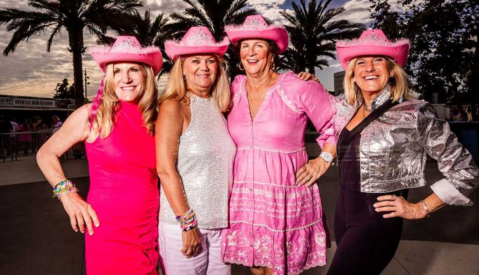 mary raser and julie klaus and christy tew and connie pittaro posing in pink cowgirl hats