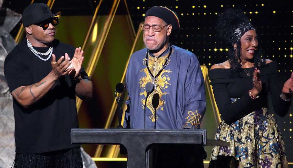 LL Cool J and Cindy Campbell present an award to DJ Kool Herc onstage at the 38th Annual Rock & Roll Hall of Fame Induction Ceremony.
