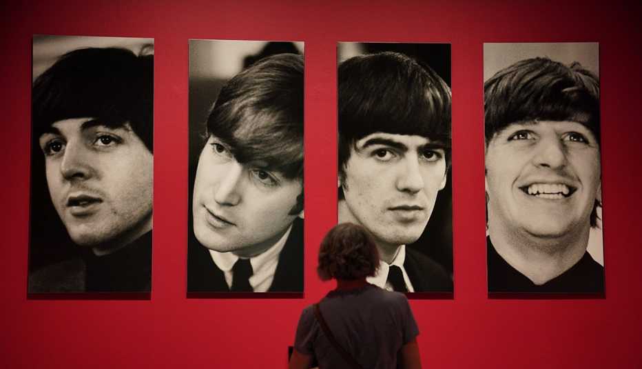 A person looking at photos of the Beatles at the Sir Paul McCartney exhibition 'Photographs 1963-64: Eyes of the Storm' at the National Portrait Gallery in London.