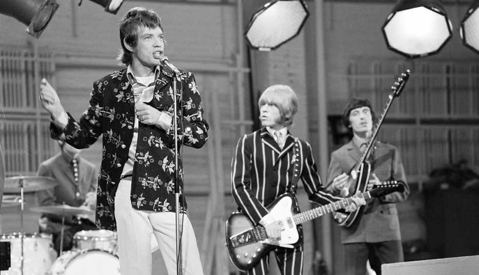 a black and white photo of the rolling stones on the ed sullivan show