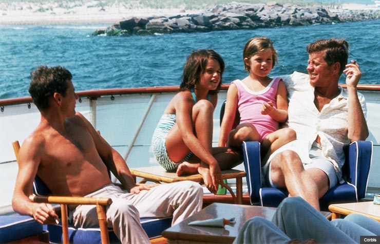 President Kennedy aboard the 'Honey Fitz' off Cape Cod, with niece Maria Shriver, and daughter, Caroline. (Corbis)