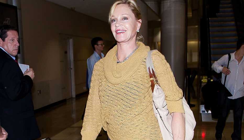 Melanie Griffith wears a cowl neck sweater