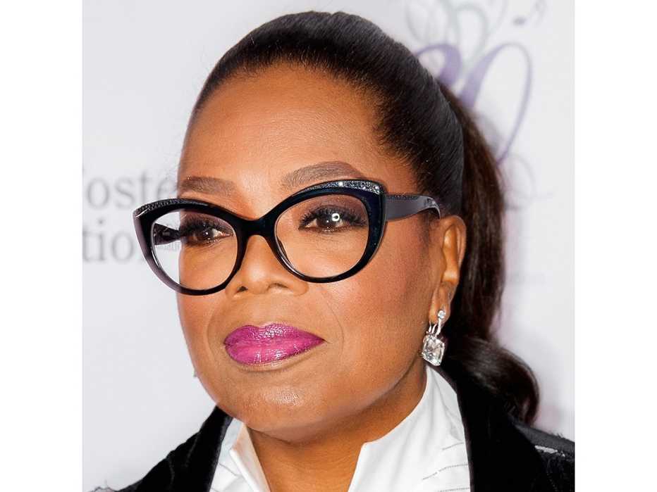 Oprah Winfrey wearing black frame glasses.