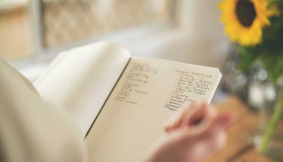 woman writing notes in a notebook 