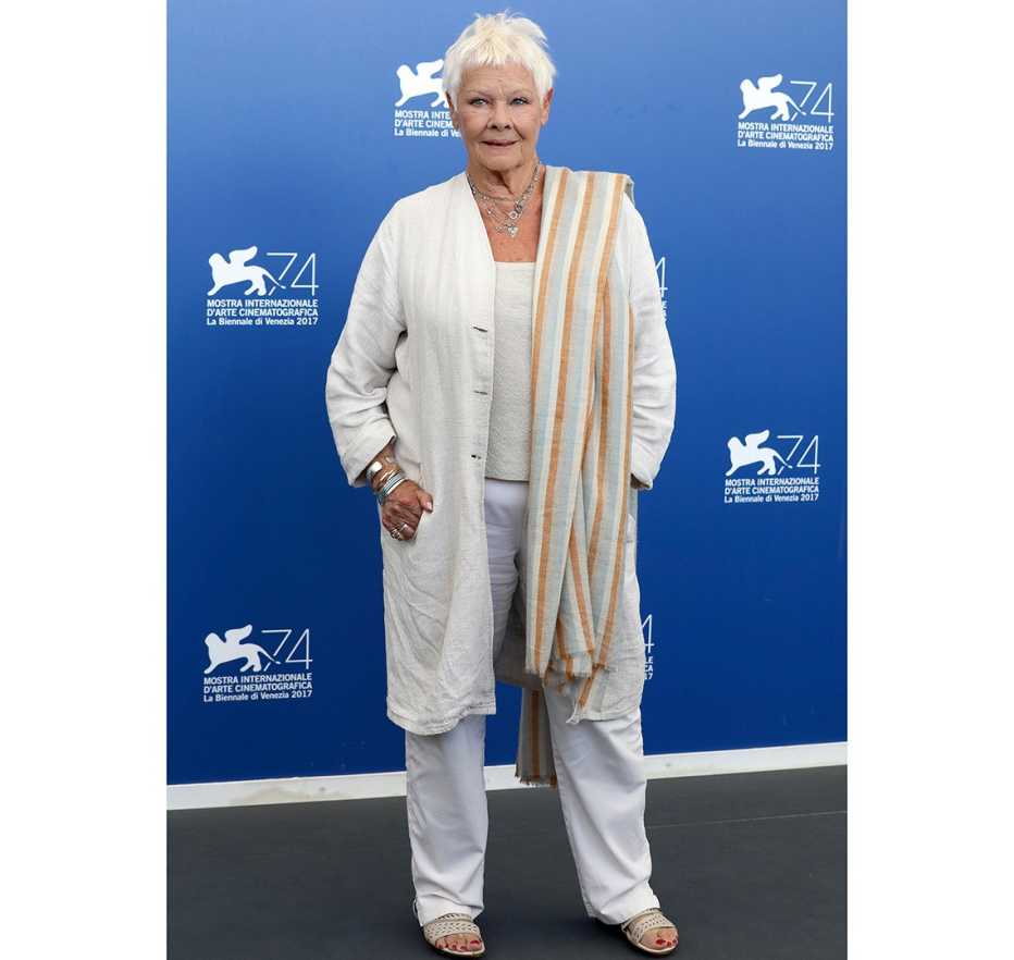 Judi Dench in a casual white duster.