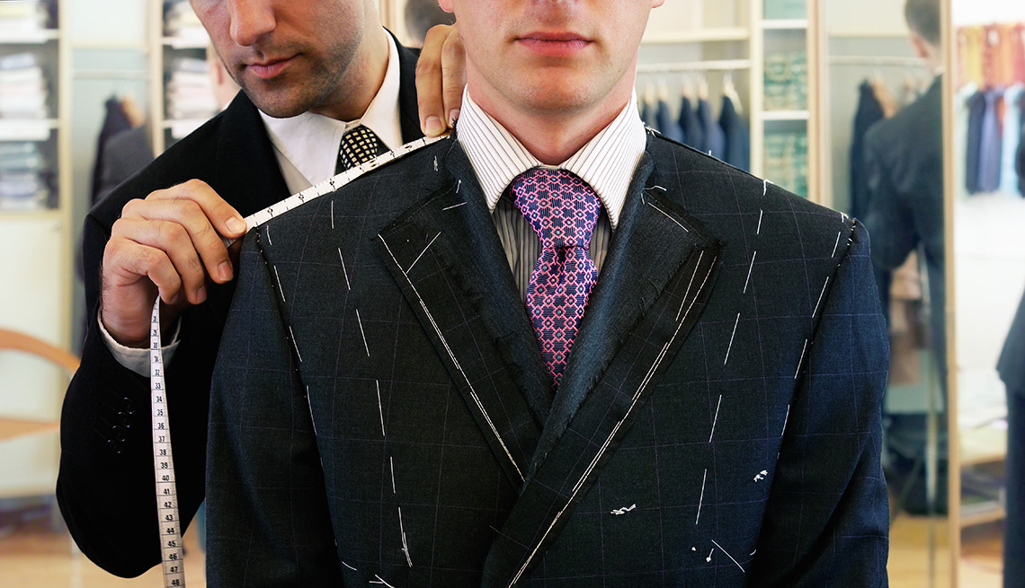 Man being fitted for suit by tailor