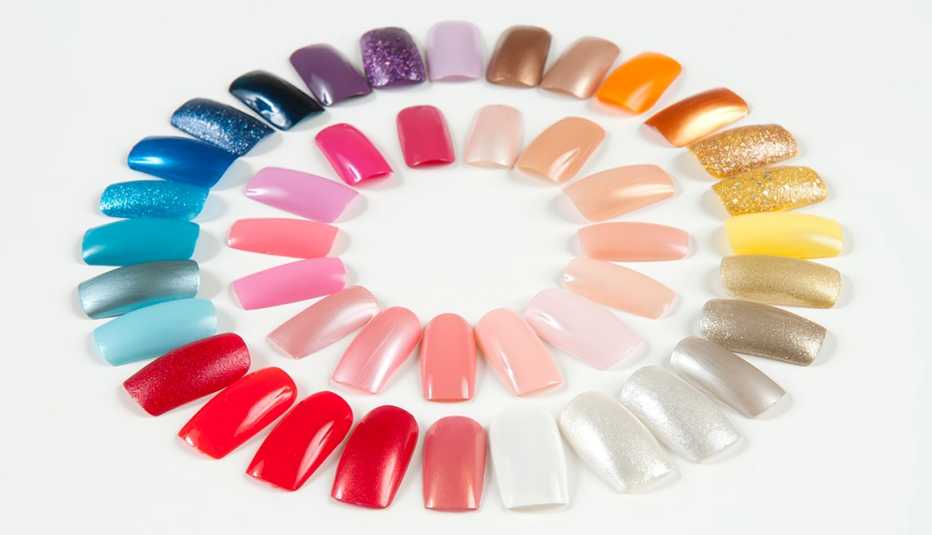 A variety of artificial nails in different colors displayed in two circular patterns
