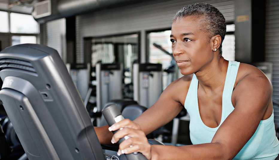 A woman using an exercise bike at the gym