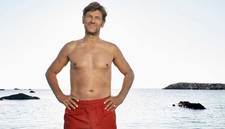 A man wearing red swimming trunks