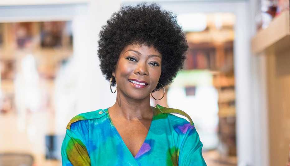A woman with natural hair smiling