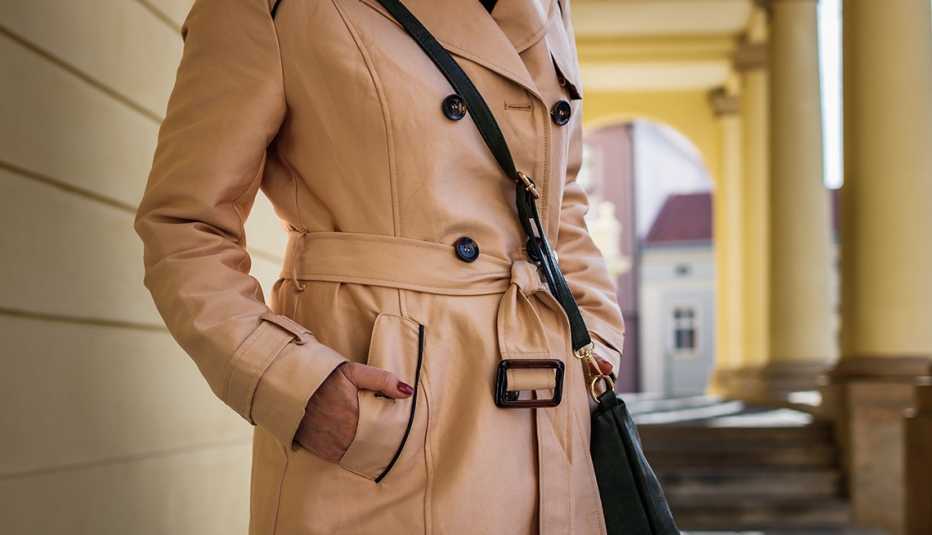 A woman wearing a beige trench coat
