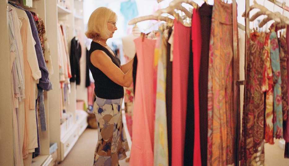 Woman browsing racks at vintage clothing store