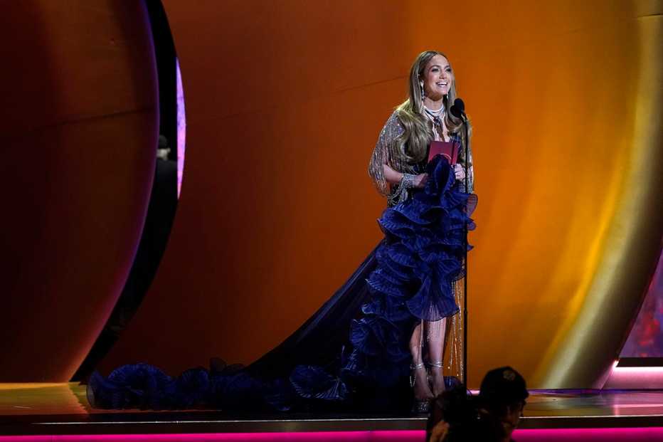 Jennifer Lopez onstage in front of the microphone as she presents the award for best pop vocal album at the 65th Grammy Awards