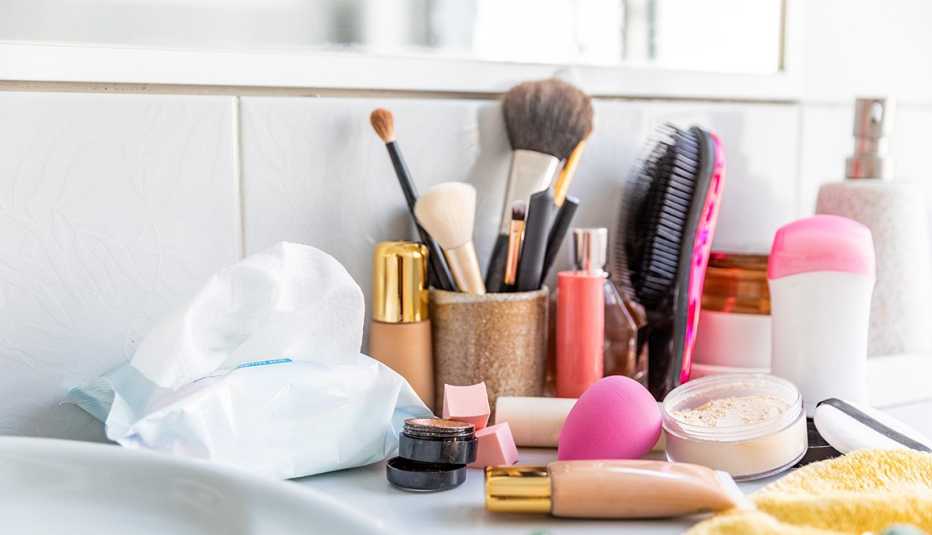 Messy and clutter cosmetics products and tools lying around on a bathroom sink
