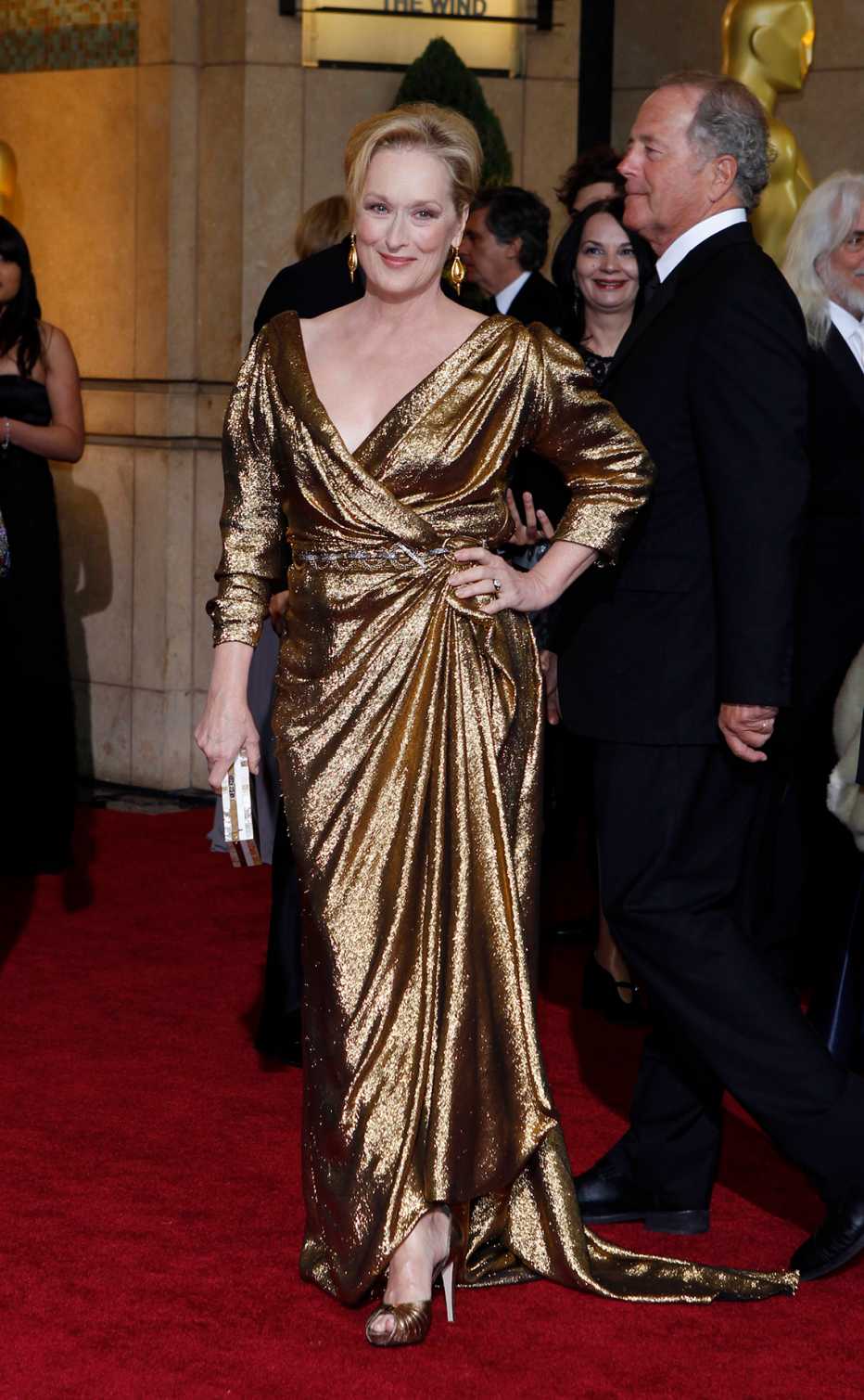 Meryl Streep wearing a gold dress on the red carpet at the 84th Annual Academy Awards