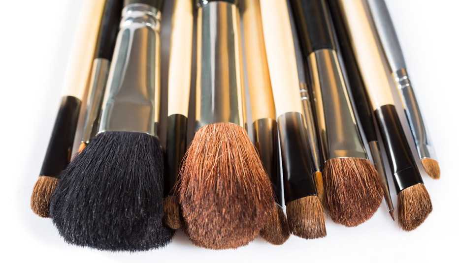 A closeup of old and used makeup brushes
