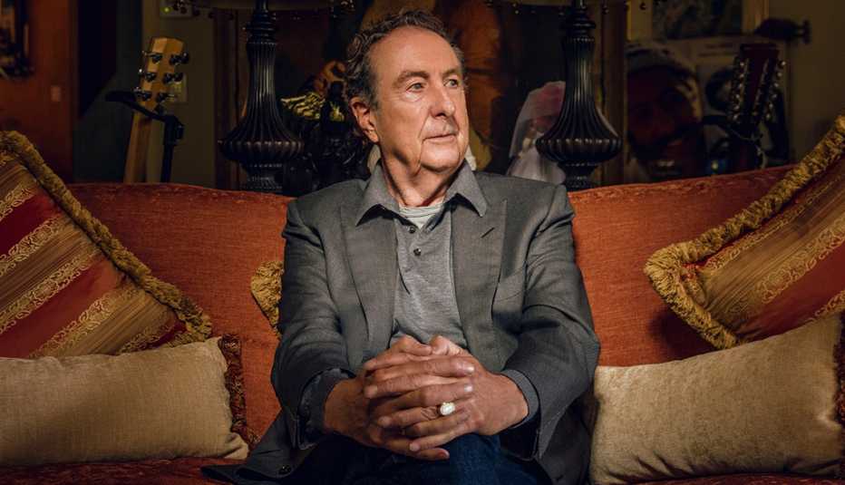 Eric Idle sitting on a couch