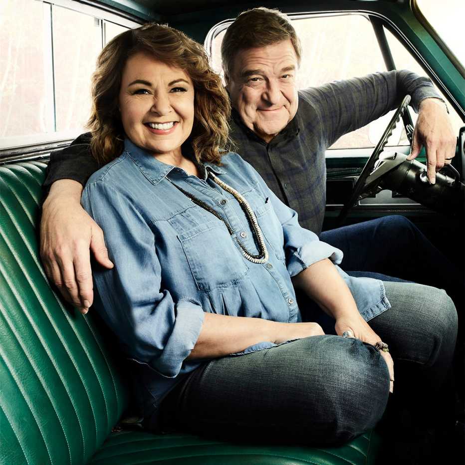 Roseanne Barr and John Goodman in the front seat of a old green pickup truck