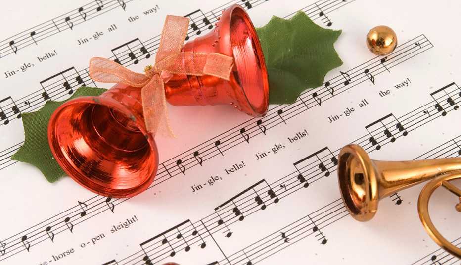Bells on top of sheet music for the song Jingle Bells