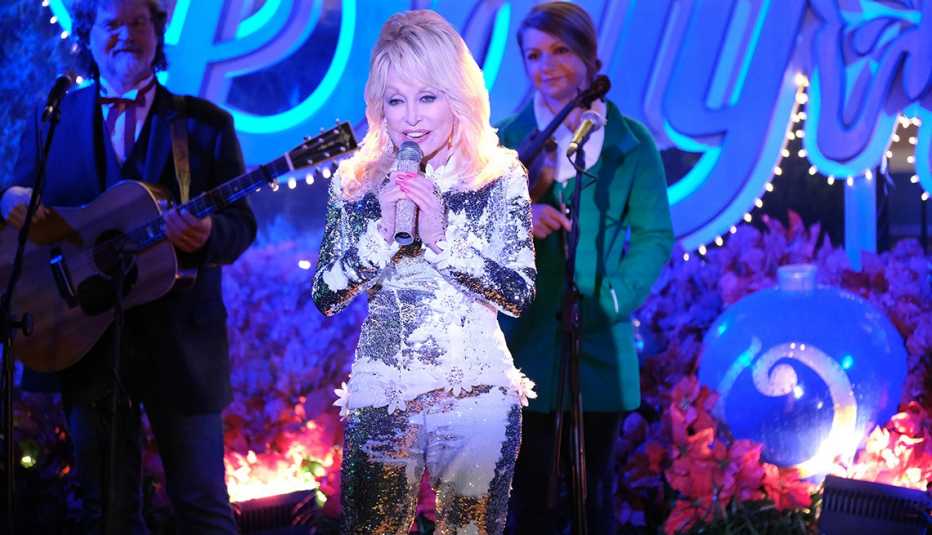 Dolly Parton singing on stage in Christmas at Dollywood
