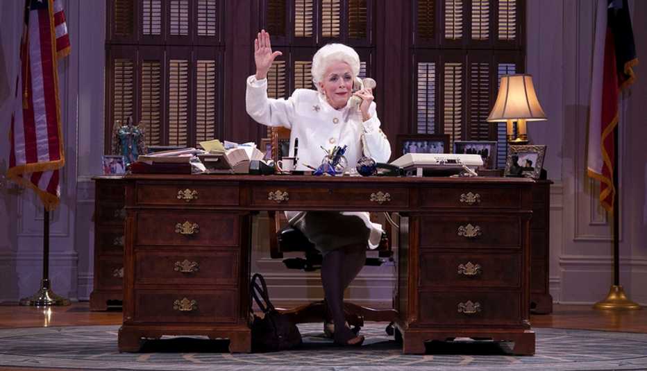 Holland Taylor sitting behind a desk while performing as iconic Texas governor Ann Richards