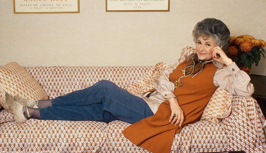 Actress Bea Arthur lying on a couch