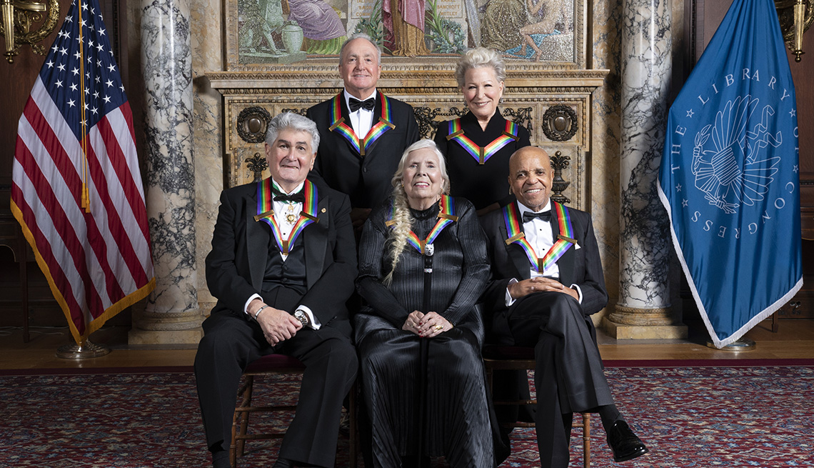 Lorne Michaels, Bette Midler, Berry Gordy, Joni Mitchell and Justino Diaz sit and stand together as part of the 44th annual Kennedy Center Honorees