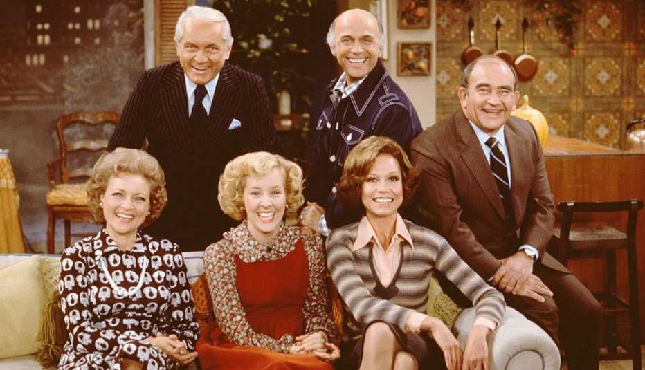 The cast of The Mary Tyler Moore Show sitting on a couch for a promotional photo