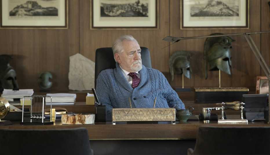 Brian Cox sitting at his office table in the HBO series Succession