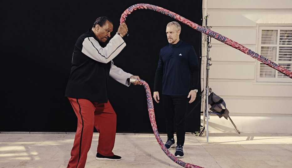 Star Wars actor Billy Dee Williams performing a ropes exercise with a trainer