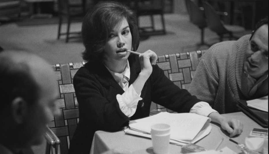Mary Tyler Moore holding a pencil to her mouth during a table read for The Dick Van Dyke Show