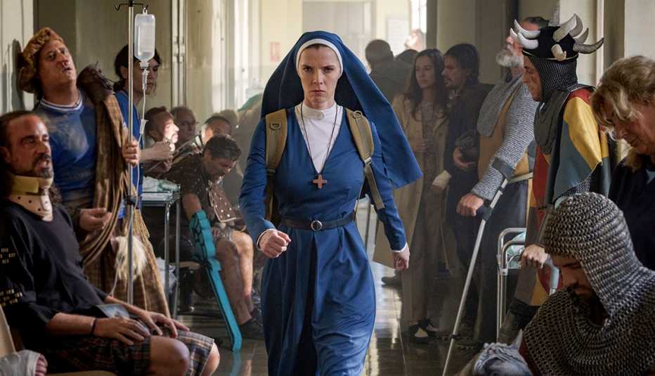 betty gilpin as simone dressed in nun outfit surrounded by people in still from mrs davis