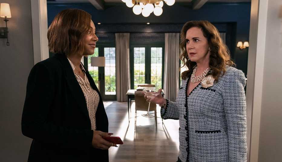 tiffany haddish and elizabeth perkins holding a cocktail look at each in a scene from the apple tv plus series the afterparty
