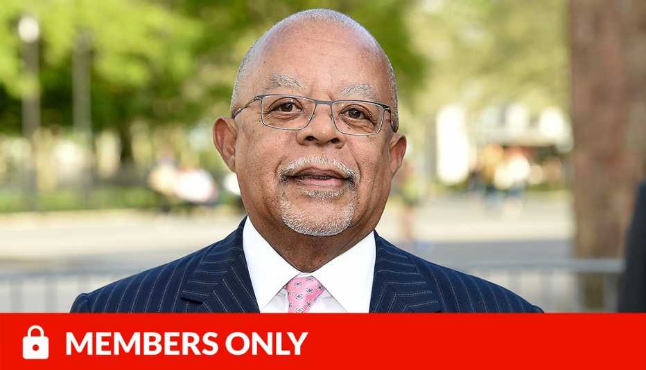 henry louis gates outside; blurred background of trees and road; red members only banner with lock icon on bottom